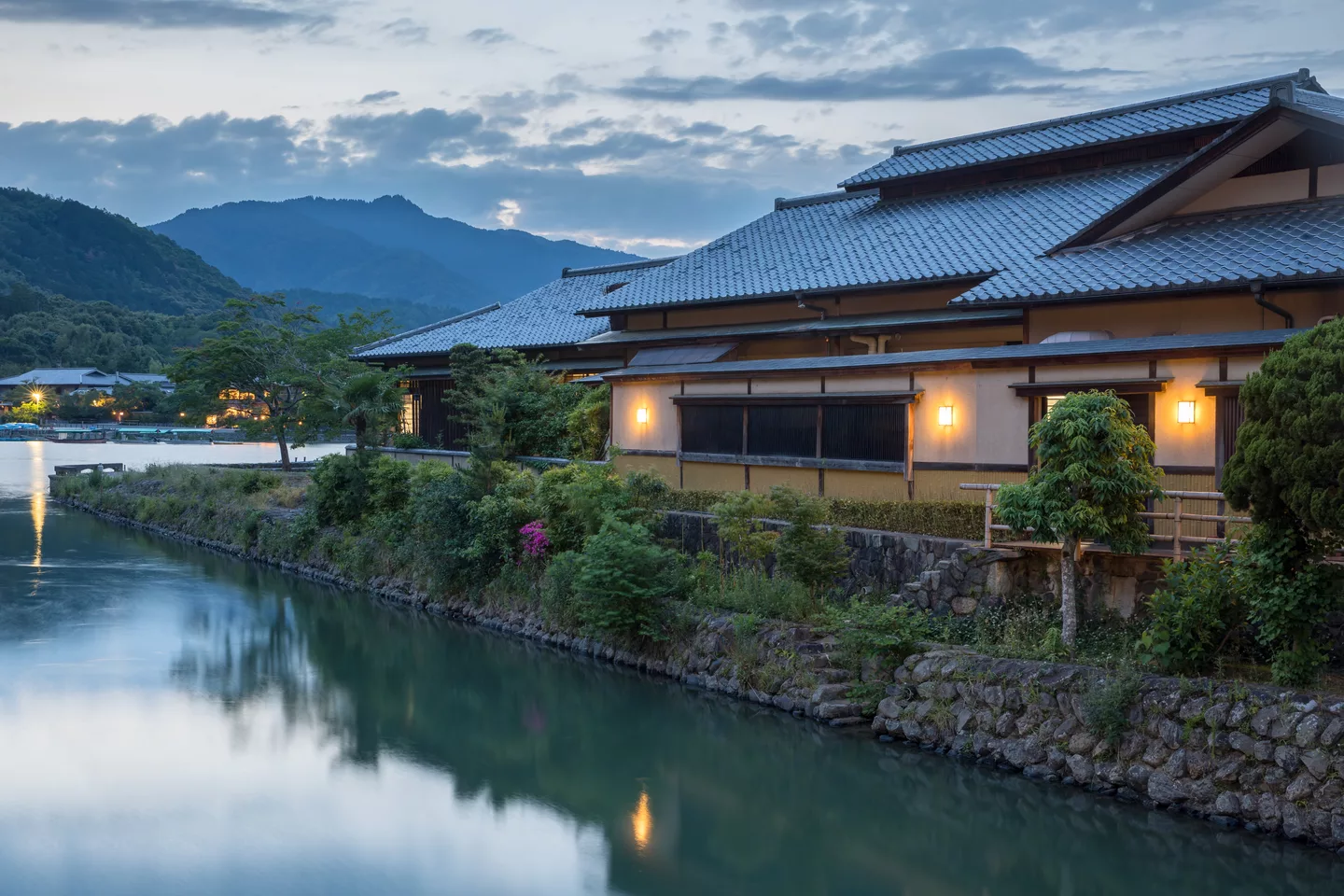 Togetsu Café old building with yellow lights at sunset on the river bank of Saganakanoshimacho island, Kyoto, Japan.jpg